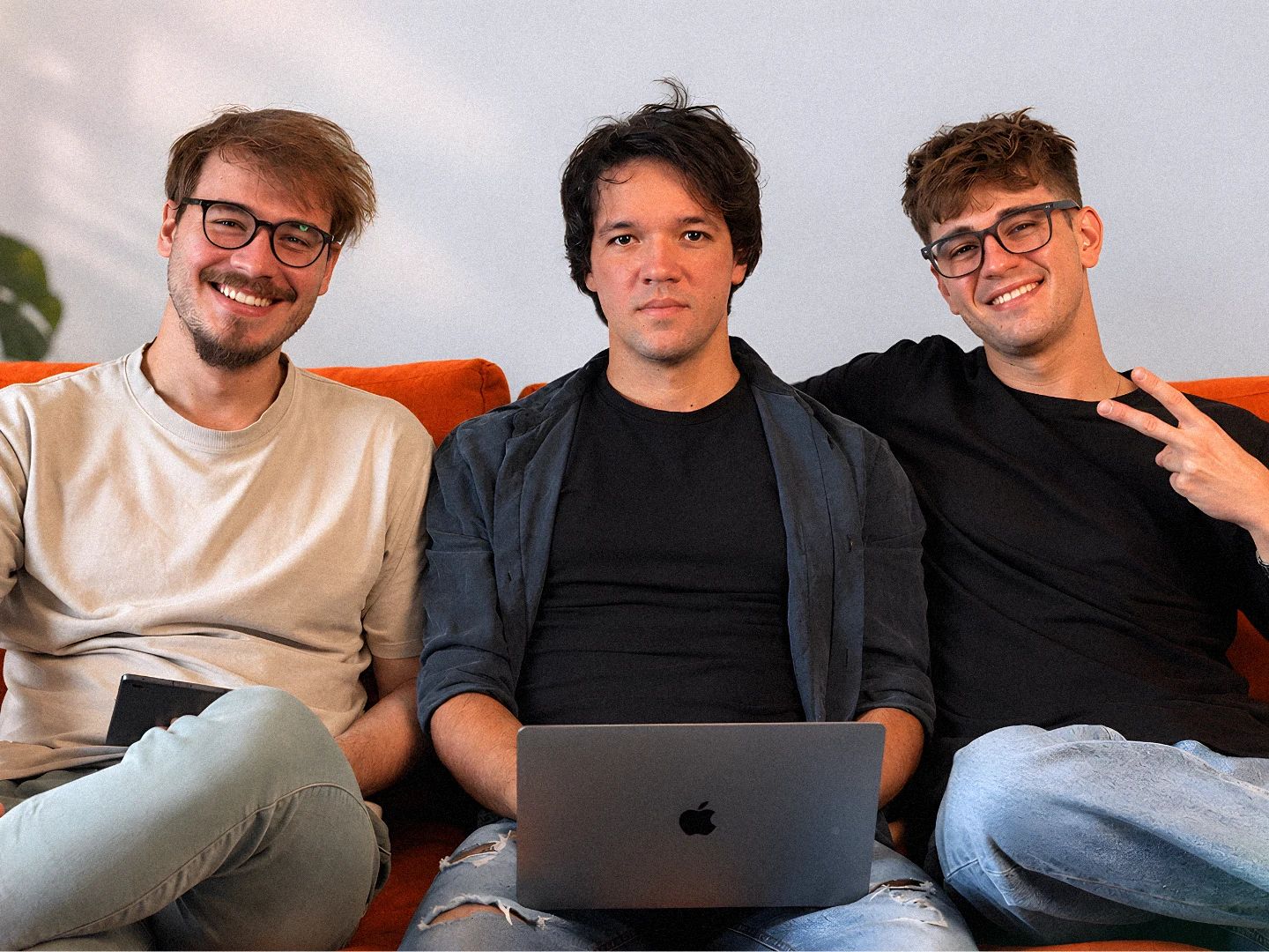 The three founders of ROOM 211 on the sofa in the studio