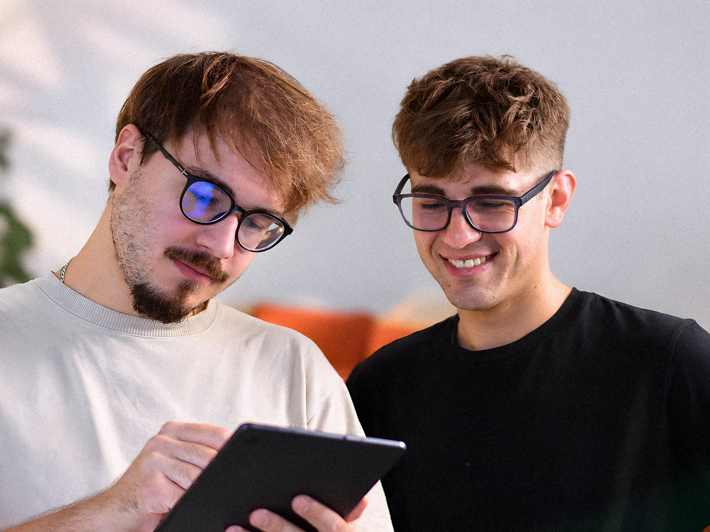Two of the team looking at a design on a tablet
