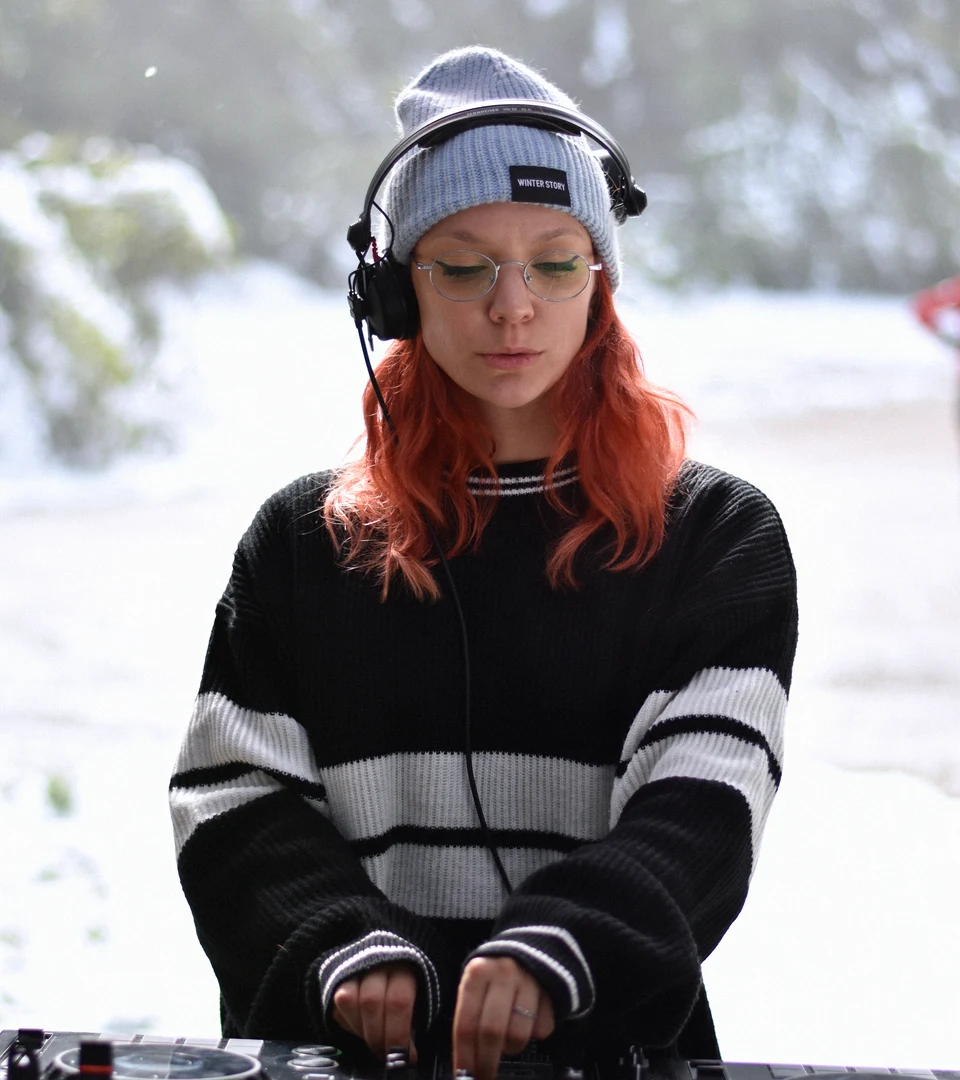 DJ in headphones and a beanie playing at the Tribalion finish